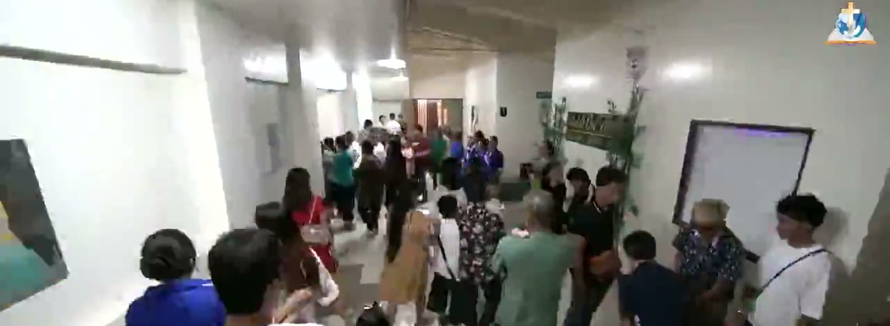 Families walking along a corridor as one service ends and the next begins